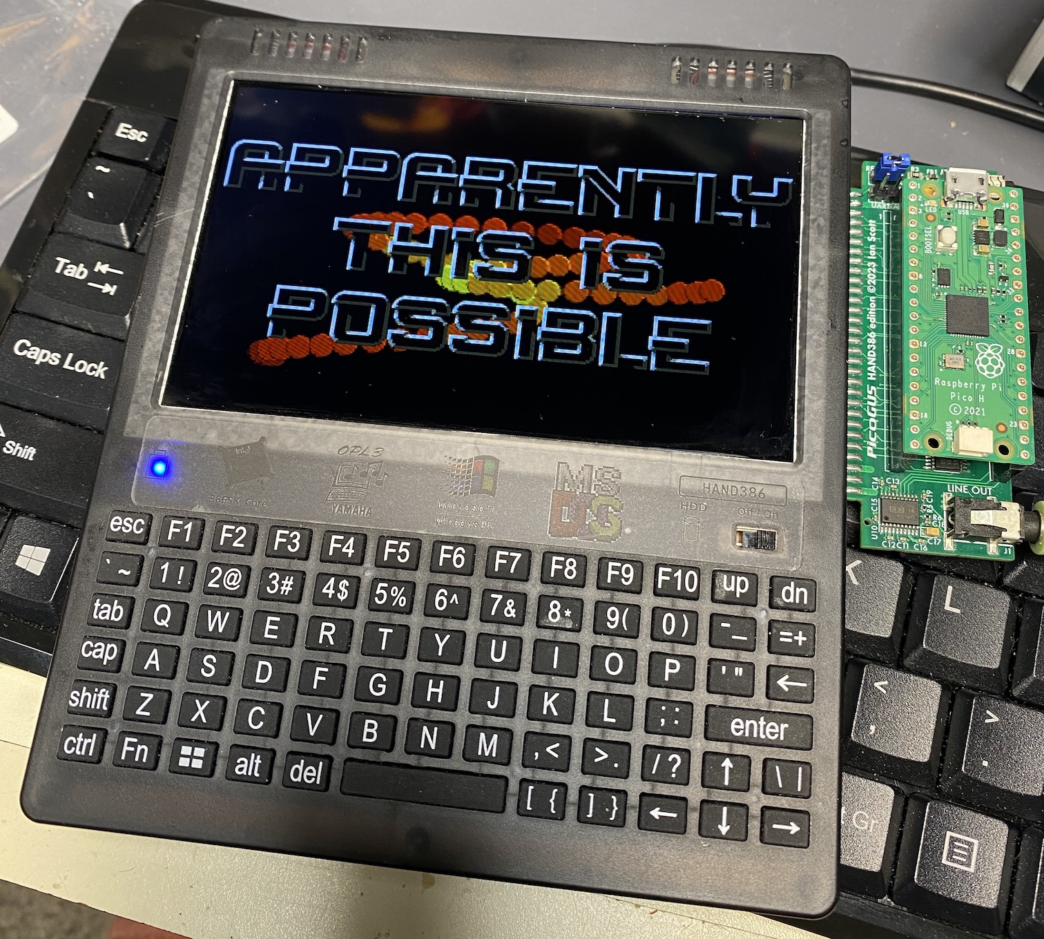 A "Femto" PicoGUS board attached to a Hand386, playing the demo Unreal by Future Crew